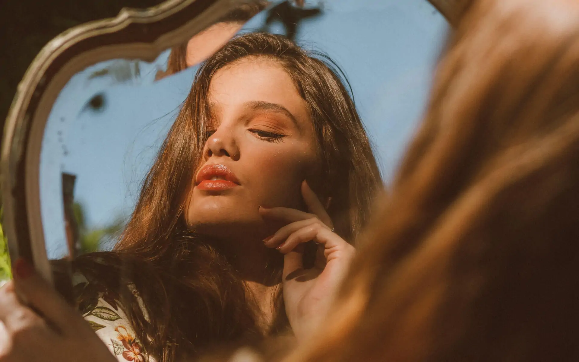 Woman's vain reflection in the mirror, representing getting identified with ego projections